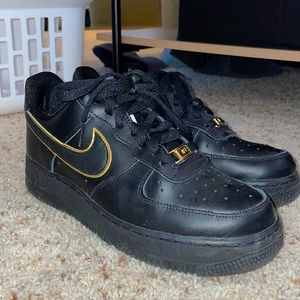 Nike Air Forces. Black and gold.